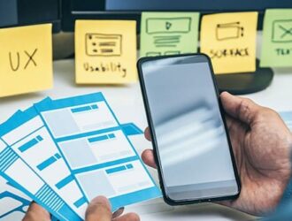 Person holding mobile with sticky notes shows UX in web application development